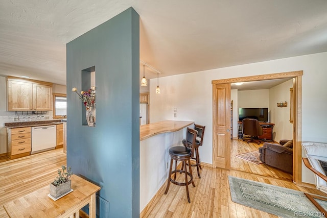 1138 E St, Salida, CO 81201 - kitchen featuring white appliances, light wood finished floors, an office area, a kitchen breakfast bar, and baseboards