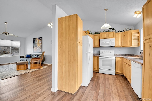 kitchen with white appliances, open floor plan, a sink, and light brown cabinetry