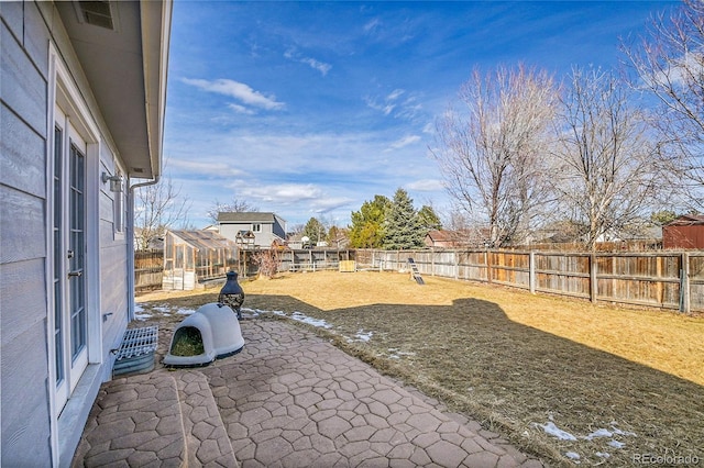 view of yard with an outbuilding, a fenced backyard, a patio, and visible vents