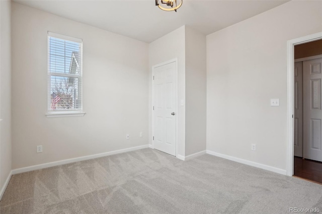 spare room featuring light colored carpet