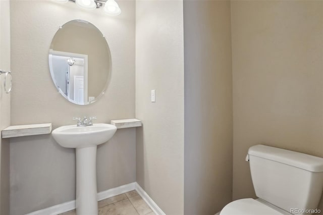 bathroom featuring tile patterned floors, toilet, and sink