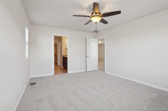 unfurnished bedroom featuring connected bathroom, ceiling fan, and light carpet