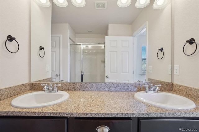 bathroom featuring vanity and an enclosed shower