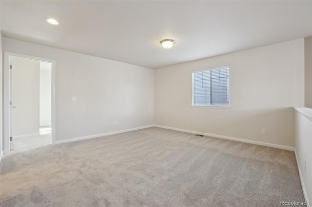 empty room featuring light carpet