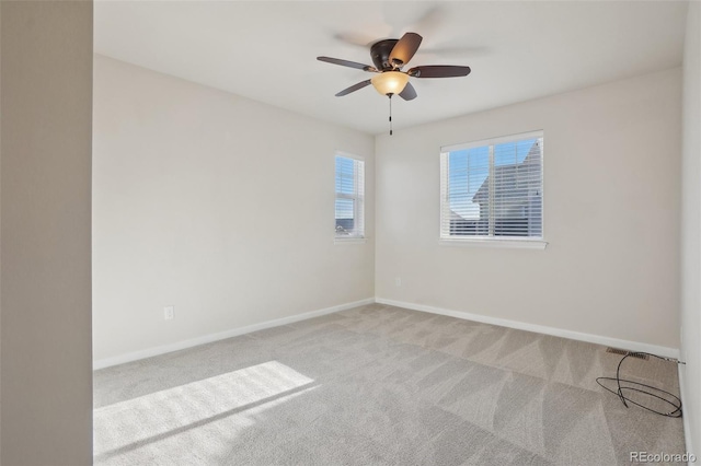 unfurnished room with ceiling fan and light carpet