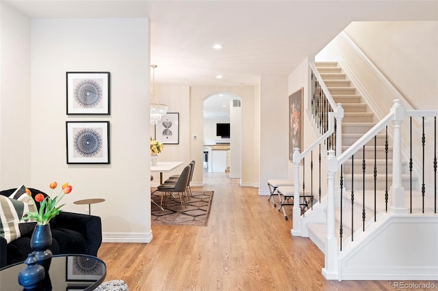 538 Cook St, Denver, CO 80206 - entrance foyer with stairs, arched walkways, wood finished floors, and recessed lighting