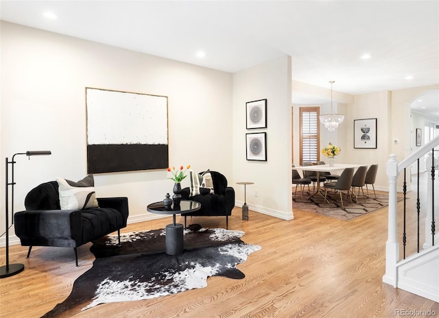 538 Cook St, Denver, CO 80206 - living area featuring arched walkways, stairway, light wood-style floors, recessed lighting, and a chandelier