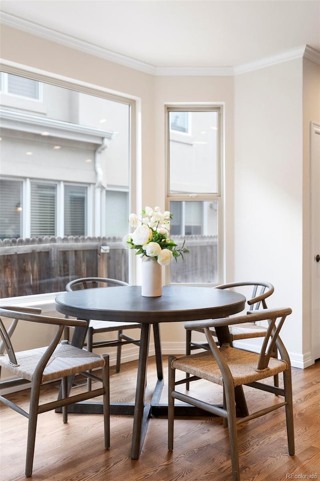 538 Cook St, Denver, CO 80206 - dining room featuring crown molding, wood finished floors, and breakfast area