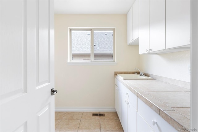 538 Cook St, Denver, CO 80206 - laundry area with a sink and light tile patterned floors