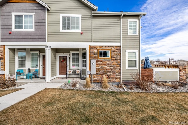 view of property featuring a patio and a front yard