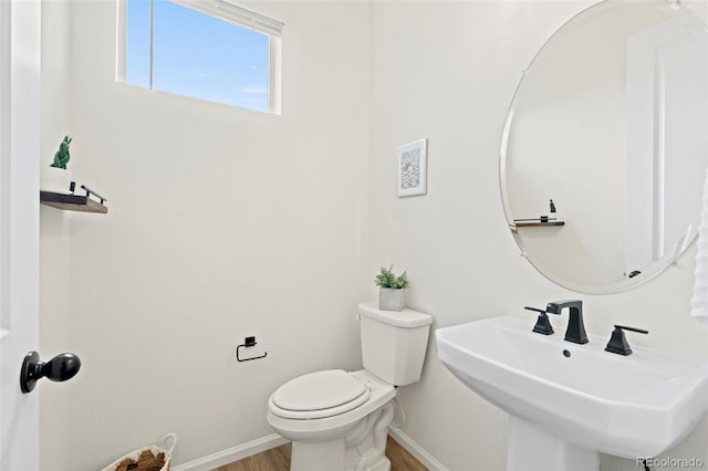21 N Edge Cliff St, Castle Rock, CO 80104 - half bath featuring a sink, toilet, wood finished floors, and baseboards