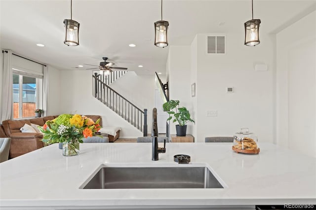 21 N Edge Cliff St, Castle Rock, CO 80104 - kitchen featuring open floor plan, a sink, recessed lighting, and decorative light fixtures