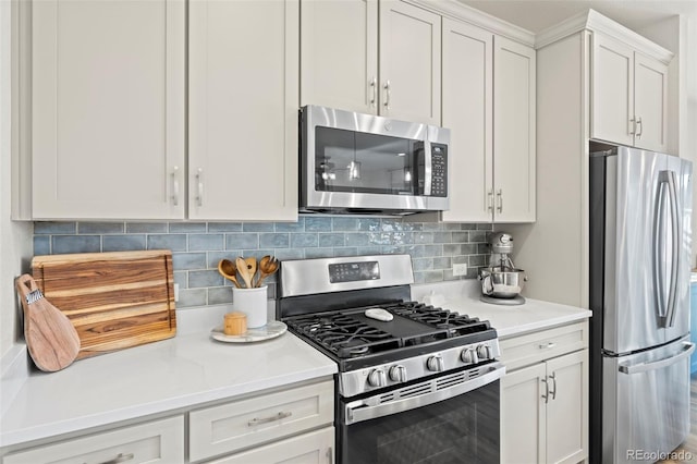 21 N Edge Cliff St, Castle Rock, CO 80104 - kitchen with appliances with stainless steel finishes, light countertops, white cabinets, and backsplash