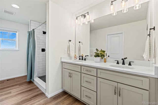 21 N Edge Cliff St, Castle Rock, CO 80104 - bathroom featuring a shower stall, double vanity, wood finished floors, and baseboards