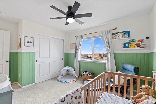 21 N Edge Cliff St, Castle Rock, CO 80104 - bedroom featuring a wainscoted wall, carpet floors, ceiling fan, and a closet