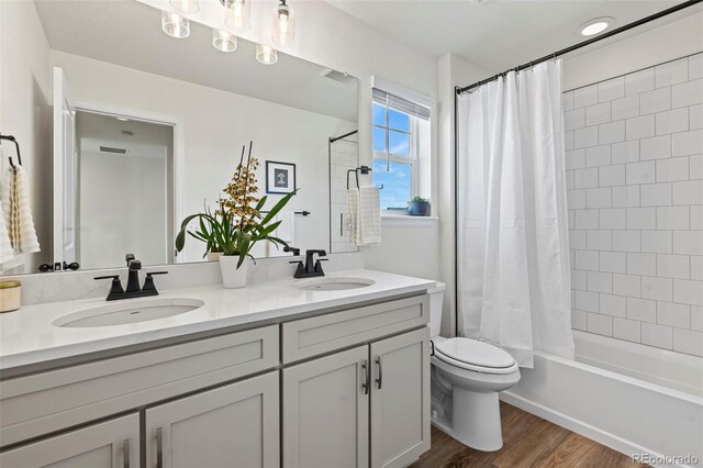 21 N Edge Cliff St, Castle Rock, CO 80104 - bathroom featuring wood finished floors, double vanity, toilet, and shower / tub combo with curtain