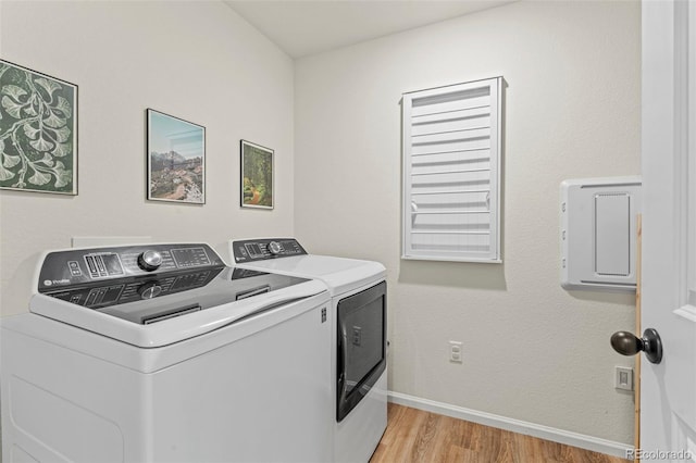 21 N Edge Cliff St, Castle Rock, CO 80104 - washroom with washing machine and clothes dryer, light wood-type flooring, and baseboards