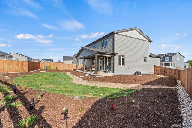 21 N Edge Cliff St, Castle Rock, CO 80104 - back of house featuring a fenced backyard, a patio, and central AC unit