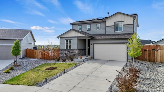 21 N Edge Cliff St, Castle Rock, CO 80104 - view of front of house featuring board and batten siding, solar panels, a garage, and fence