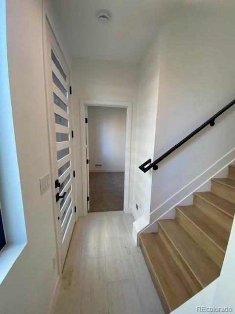 stairway with wood-type flooring