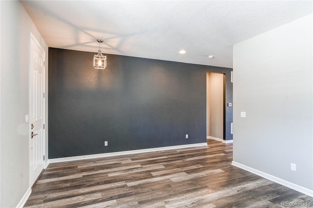 spare room featuring dark hardwood / wood-style flooring