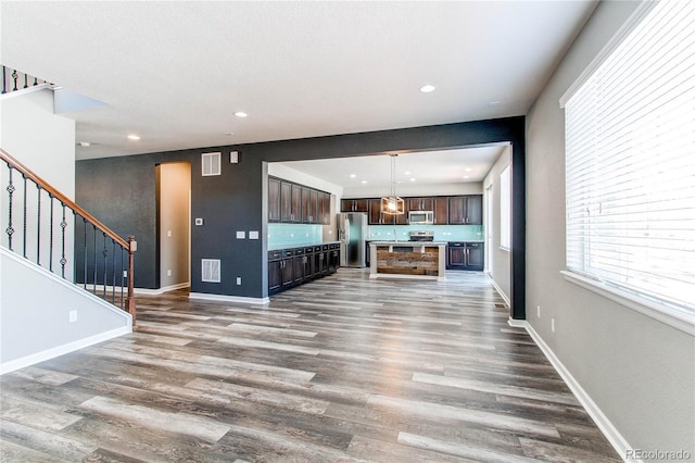 unfurnished living room with dark hardwood / wood-style flooring