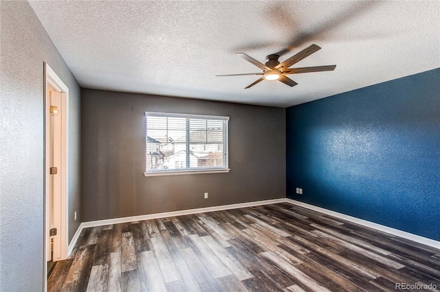 empty room featuring a textured ceiling, dark wood-type flooring, and ceiling fan