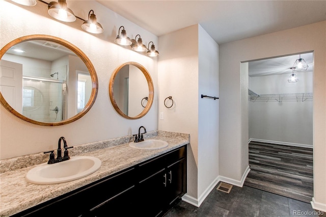 bathroom with vanity and a shower with shower door