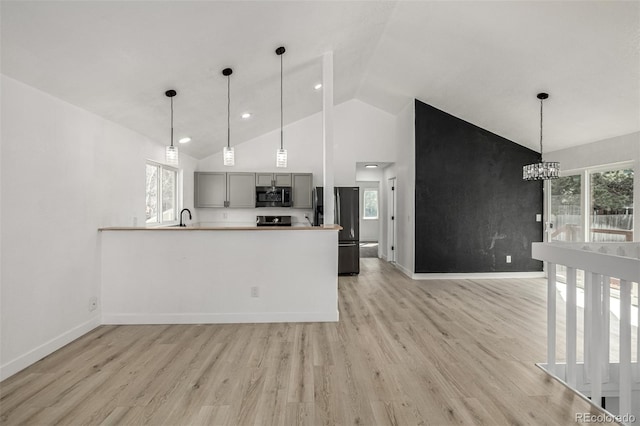 kitchen with a wealth of natural light, light wood-type flooring, and appliances with stainless steel finishes