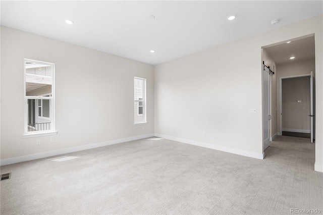 7392 Timberstone St, Castle Pines, CO 80108 - unfurnished room featuring light carpet, a barn door, recessed lighting, baseboards, and a smoke detector