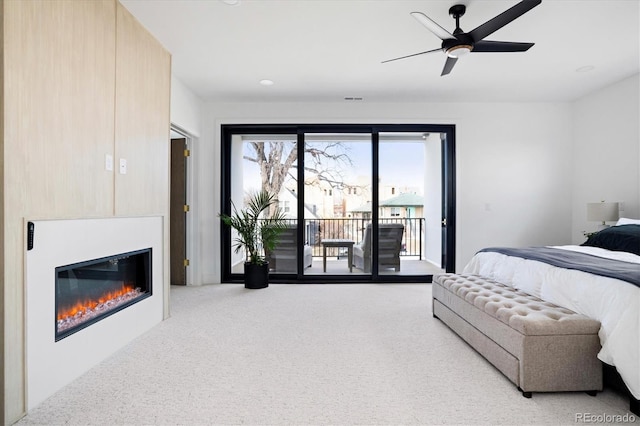 carpeted bedroom featuring ceiling fan and access to exterior