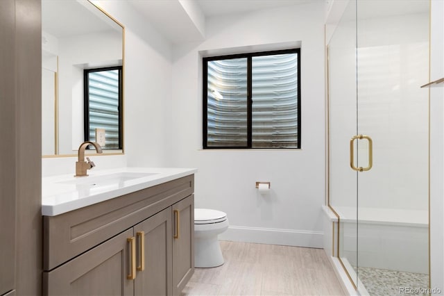 bathroom featuring walk in shower, vanity, and toilet