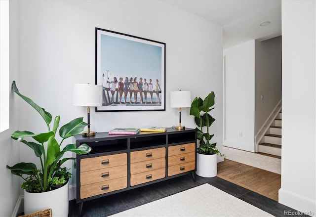 interior space with stairway, baseboards, and dark wood-type flooring