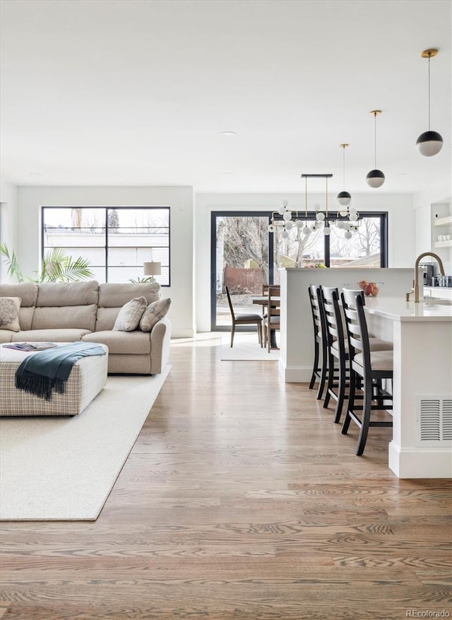 living room with sink and light hardwood / wood-style flooring