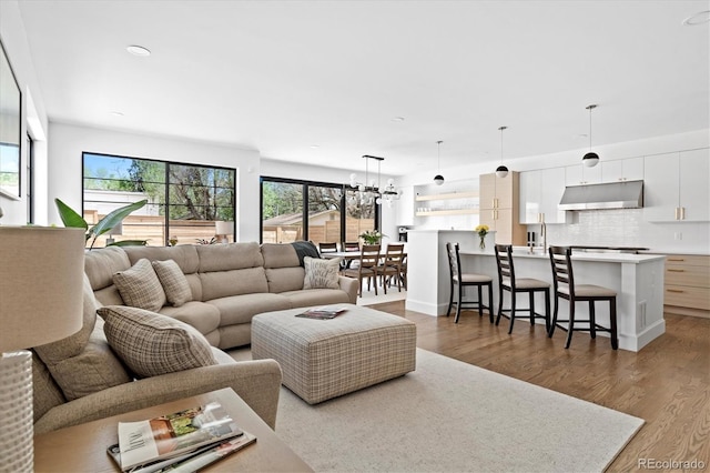 living room with hardwood / wood-style flooring and an inviting chandelier