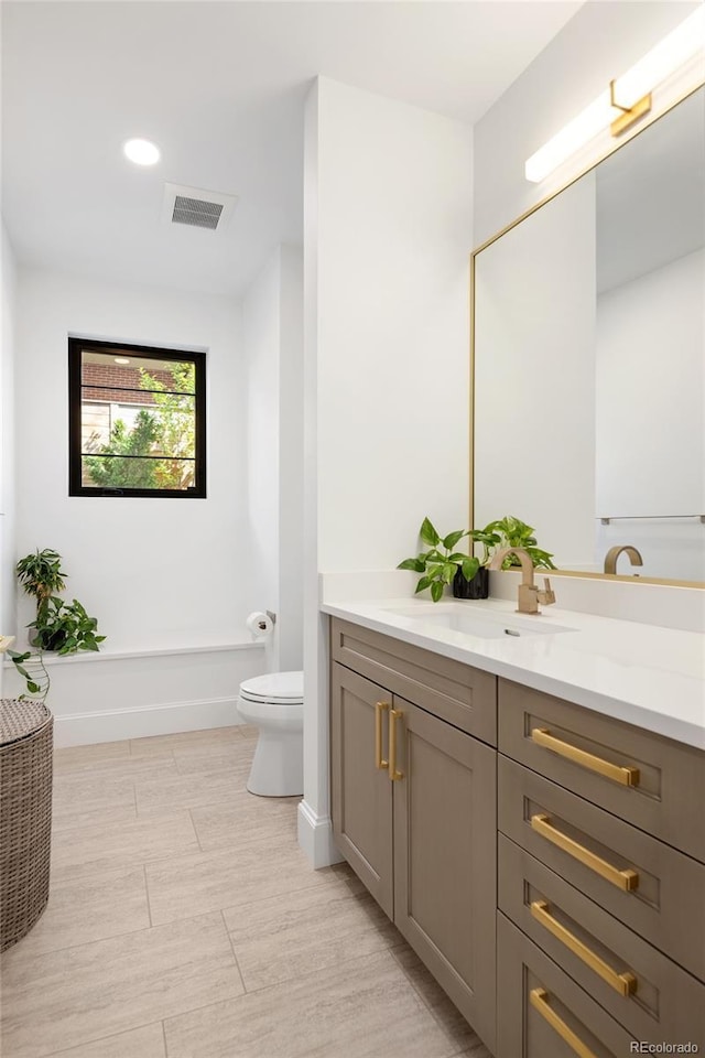 full bath featuring visible vents, recessed lighting, toilet, and vanity