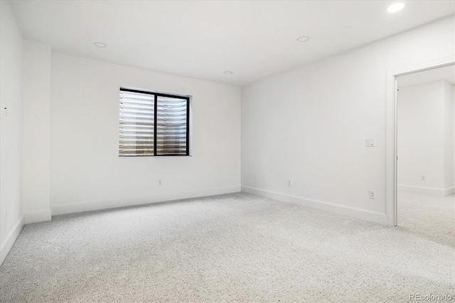 carpeted spare room with baseboards and recessed lighting