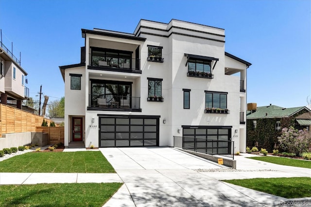 view of front facade featuring a garage, fence, a balcony, concrete driveway, and stucco siding