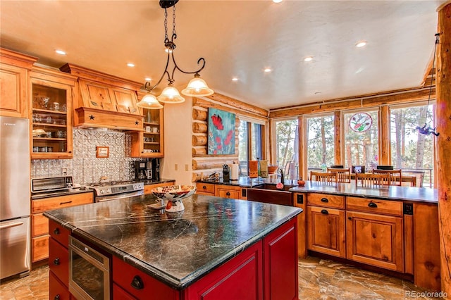 kitchen featuring backsplash, dark stone countertops, decorative light fixtures, a kitchen island, and stainless steel appliances