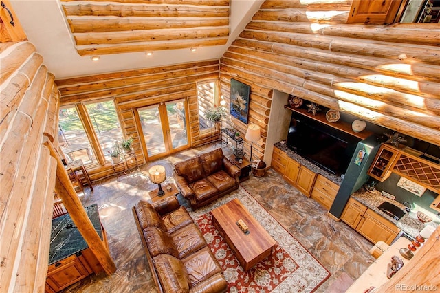 living room featuring rustic walls and sink