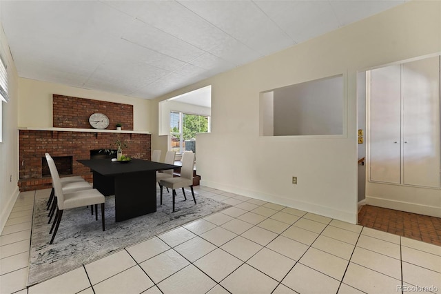 920 Emerson Cir, Northglenn, CO 80233 - dining area with light tile patterned floors and a brick fireplace