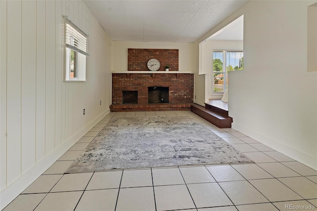 920 Emerson Cir, Northglenn, CO 80233 - unfurnished living room featuring tile patterned flooring and a brick fireplace