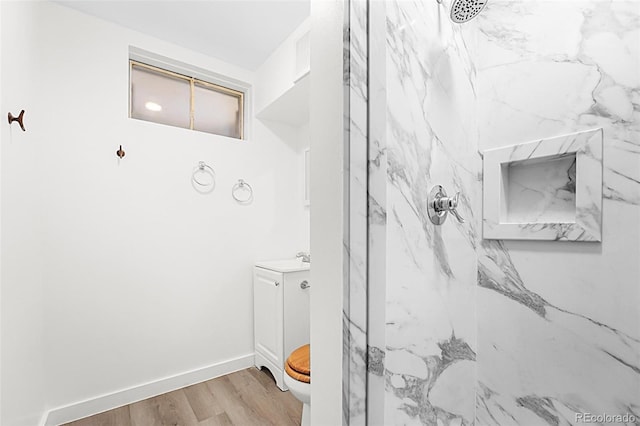 920 Emerson Cir, Northglenn, CO 80233 - bathroom with a marble finish shower, vanity, and wood finished floors