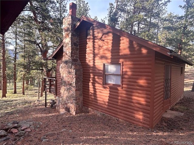 861 Happy Top Trl, Bailey, CO 80421 - view of side of home featuring a chimney and faux log siding