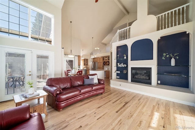 living room featuring high vaulted ceiling, french doors, hardwood / wood-style flooring, and beamed ceiling