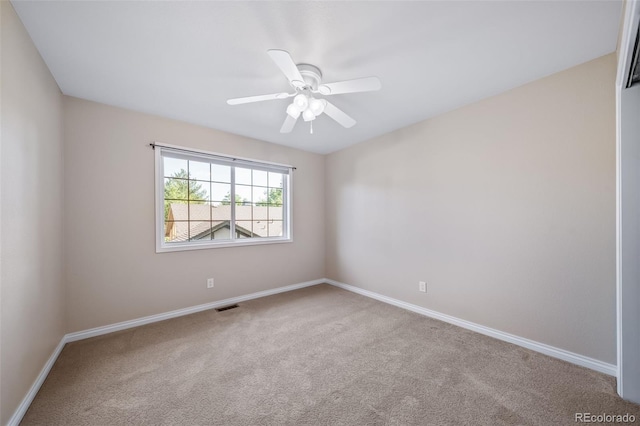 unfurnished room featuring ceiling fan and carpet flooring