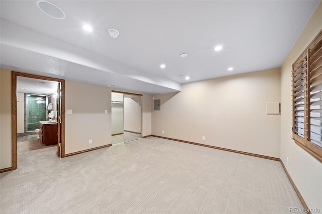 basement with electric panel and light carpet