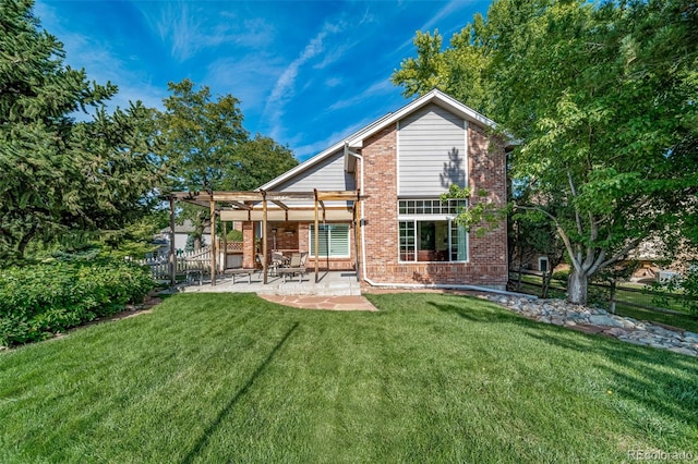 rear view of house with a patio area and a yard