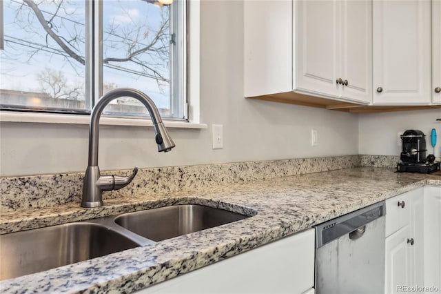 kitchen featuring white cabinetry, sink, light stone counters, and dishwasher