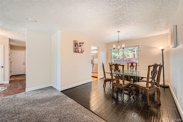 dining area with a chandelier, a textured ceiling, and dark hardwood / wood-style floors